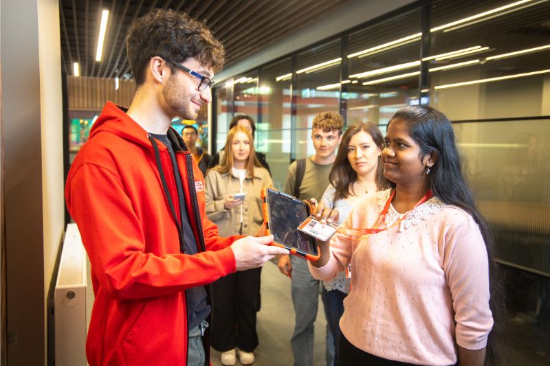 a student assistant taking student numbers for event attendance